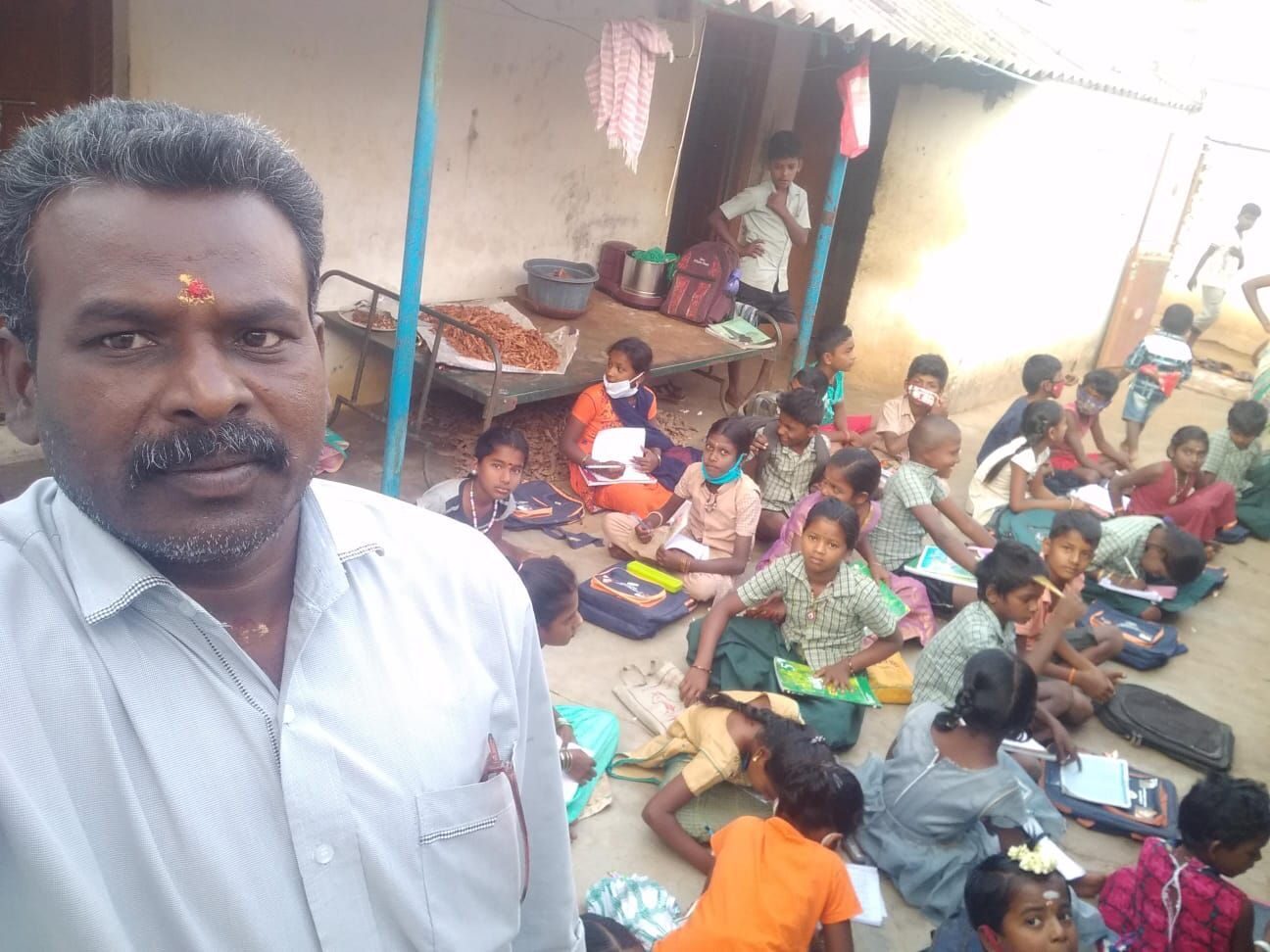 Children studying at an outdoor tuition class